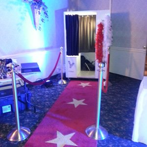 Booth with red carpet and ropes